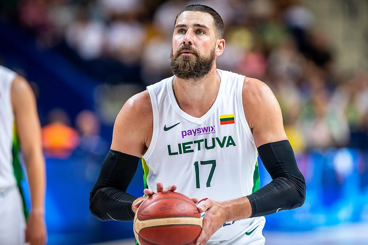 Jonas Valančiūnas in a Lithuania basketball jersey holding a basketball during a game