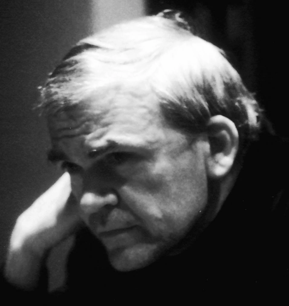 Black-and-white portrait of Milan Kundera looking downward in profile.
